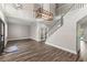 Inviting foyer with sleek wood floors, staircase, and modern lighting fixtures, creating a grand entrance at 1467 Selbydon Way, Winter Garden, FL 34787