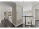 Hallway with wood floors and black and white trim offering views to the lower level at 1467 Selbydon Way, Winter Garden, FL 34787