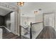 Hallway with wood floors and black and white trim offering views to the lower level at 1467 Selbydon Way, Winter Garden, FL 34787