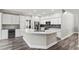 Bright kitchen with stainless steel appliances and a large island with a quartz countertop at 1467 Selbydon Way, Winter Garden, FL 34787