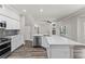 Open kitchen with modern stainless-steel appliances and stone countertops with seating space at 1467 Selbydon Way, Winter Garden, FL 34787