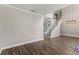 Spacious living area with dark floors, staircase, and modern lighting fixtures at 1467 Selbydon Way, Winter Garden, FL 34787