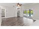 Open-concept living room with hardwood floors and a sliding glass door leading to the pool area at 1467 Selbydon Way, Winter Garden, FL 34787