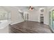 Open-concept living area with dark floors and sliding glass doors, open to a kitchen at 1467 Selbydon Way, Winter Garden, FL 34787