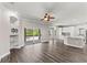 Open-concept living area with dark floors, sliding glass doors to the pool and modern lighting fixtures at 1467 Selbydon Way, Winter Garden, FL 34787