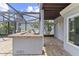 Outdoor kitchen with built in grill and brick floors in screened lanai at 1467 Selbydon Way, Winter Garden, FL 34787