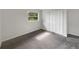 Bedroom featuring neutral paint, carpet, closet, and window at 1623 Crestlawn Ave, Orlando, FL 32811