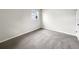 Cozy bedroom with neutral paint, plush carpeting, and natural light at 1623 Crestlawn Ave, Orlando, FL 32811