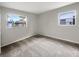 Comfortable carpeted bedroom with two bright windows at 1623 Crestlawn Ave, Orlando, FL 32811