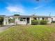 Charming single-story home with manicured lawn, carport, and attractive landscaping at 1623 Crestlawn Ave, Orlando, FL 32811