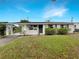 Charming single-story home featuring a carport and well-maintained front lawn at 1623 Crestlawn Ave, Orlando, FL 32811