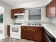 Kitchen with wooden cabinets, white appliances, and a double stainless-steel sink at 1623 Crestlawn Ave, Orlando, FL 32811