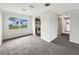 Bright living room with plush carpet and an open view of the adjacent kitchen at 1623 Crestlawn Ave, Orlando, FL 32811