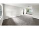 Spacious living room with carpet, bright windows, and neutral wall color at 1623 Crestlawn Ave, Orlando, FL 32811