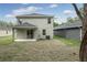 Backyard featuring a covered patio, well-maintained lawn, and exterior of a modern home at 164 14Th Ave, Longwood, FL 32750