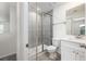 A bathroom boasts a glass shower, white cabinets, quartz counters, and a gray tile at 164 14Th Ave, Longwood, FL 32750