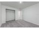 A bright bedroom featuring gray carpet, white walls, with a closet and doorway at 164 14Th Ave, Longwood, FL 32750
