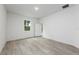 A light-filled bedroom features wood-look floors and neutral paint, with a window to the backyard at 164 14Th Ave, Longwood, FL 32750