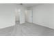 A bright bedroom featuring gray carpet, white walls, with a closet and doorway at 164 14Th Ave, Longwood, FL 32750