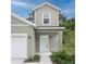 Inviting front entrance with a classic white door, manicured landscaping, and neutral color scheme at 164 14Th Ave, Longwood, FL 32750