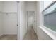 Hallway featuring wood-look flooring, white walls, and doors leading to a closet and other rooms at 164 14Th Ave, Longwood, FL 32750