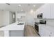 Well-equipped kitchen with quartz counters, stainless appliances, and modern lighting at 164 14Th Ave, Longwood, FL 32750