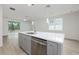 Modern kitchen island featuring quartz counters, stainless dishwasher, and an open design at 164 14Th Ave, Longwood, FL 32750