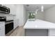 Bright, modern kitchen features stainless appliances, quartz counters, and open layout at 164 14Th Ave, Longwood, FL 32750