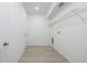 Clean, white laundry room with vinyl flooring and wire shelving for optimal storage at 164 14Th Ave, Longwood, FL 32750
