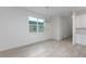 Inviting living area with ample natural light, modern chandelier, and light wood flooring at 164 14Th Ave, Longwood, FL 32750