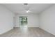 Spacious living area features sliding glass doors, and light gray wood floors at 164 14Th Ave, Longwood, FL 32750