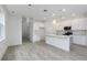 Open concept kitchen featuring white cabinets, quartz counters, and an eat-in island at 164 14Th Ave, Longwood, FL 32750