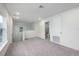 Cozy loft area with carpet flooring, a staircase, and access to a bathroom, perfect for relaxing or entertaining at 164 14Th Ave, Longwood, FL 32750