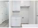 Functional mud room featuring white cabinets, quartz counters, and utility hookups at 164 14Th Ave, Longwood, FL 32750