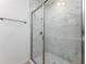 This shower features a glass door, marble-look tile, and hexagon tile on the floor at 164 14Th Ave, Longwood, FL 32750