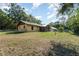 Large backyard features mature trees and a view of the back of the house at 175 Cliff St, Deland, FL 32720