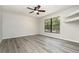 A spacious bedroom featuring a ceiling fan, closet, and a large window at 175 Cliff St, Deland, FL 32720
