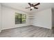 A spacious bedroom featuring a ceiling fan, closet, and a large window at 175 Cliff St, Deland, FL 32720