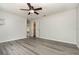 A spacious bedroom featuring a ceiling fan, closet, and a large window at 175 Cliff St, Deland, FL 32720