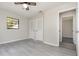 This spacious bedroom is light and airy with gray wood-look flooring and closet space at 175 Cliff St, Deland, FL 32720