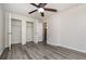 A bright bedroom featuring a ceiling fan, closet, and a large window at 175 Cliff St, Deland, FL 32720