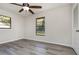 A bright bedroom featuring a ceiling fan, closet, and a large window at 175 Cliff St, Deland, FL 32720