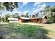 Home exterior with spacious lawn and carport, showing the home's position on a roomy lot at 175 Cliff St, Deland, FL 32720