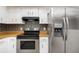 This kitchen has stainless steel appliances, white cabinets, and wood countertops at 175 Cliff St, Deland, FL 32720