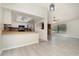Open concept dining and kitchen area with modern light fixtures, breakfast bar, and views of the fireplace at 175 Cliff St, Deland, FL 32720