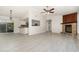 Open-concept living area showing fireplace, tiled floors, adjacent kitchen, and sliding doors to screened porch at 175 Cliff St, Deland, FL 32720