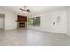 Bright living room with a stone fireplace, ceiling fan, and a large window at 175 Cliff St, Deland, FL 32720