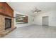 Cozy living room featuring a stone fireplace, large window, and entryway at 175 Cliff St, Deland, FL 32720
