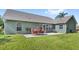 Spacious backyard featuring a well-maintained lawn and outdoor patio with dining furniture at 1880 Lorraine Way, St Cloud, FL 34769