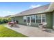 Spacious backyard patio offers outdoor seating and dining, ideal for entertaining or relaxation at 1880 Lorraine Way, St Cloud, FL 34769